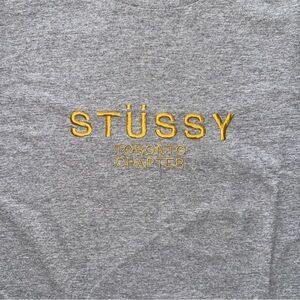 Stussy Toronto Chapter Gray T-Shirt with Gold Embroidery